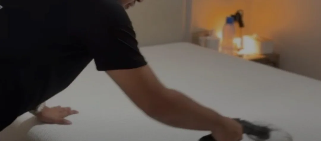 M Clean crew member cleaning a mattress
