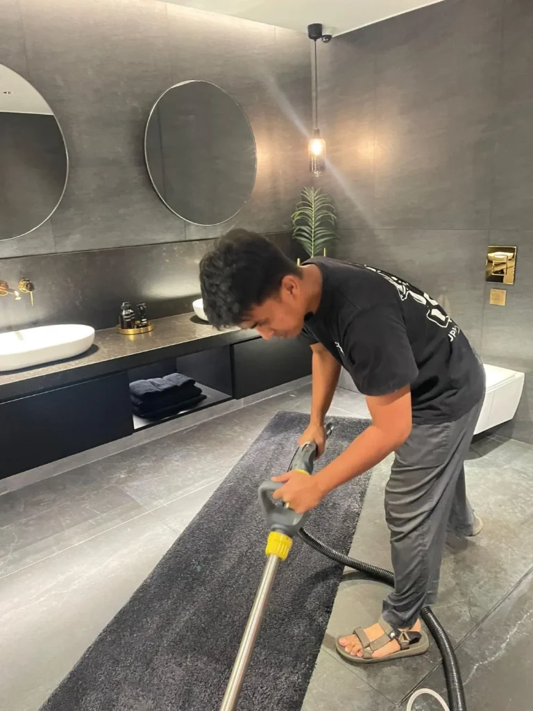 Rug cleaning in a dark bathroom showroom