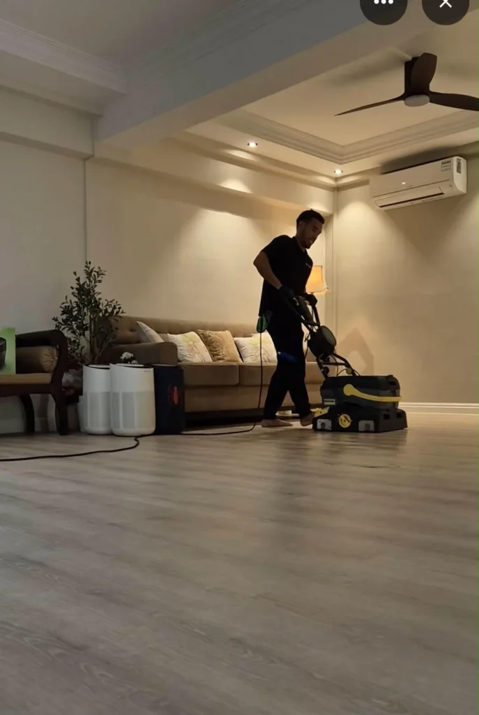 M Clean crew member polishing a living room floor