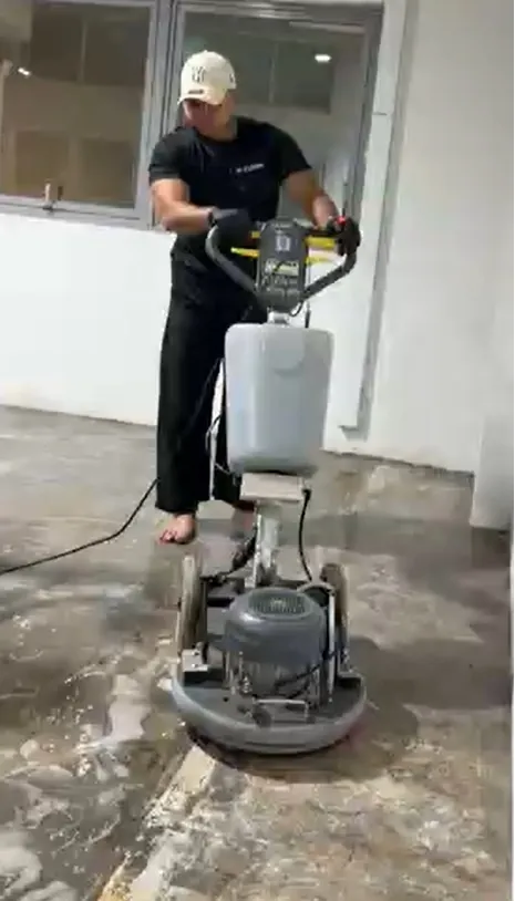 M Clean crew member using a rotary floor machine